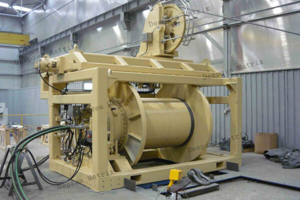 A large heavy-duty hydraulic winch on an offshore vessel deck.