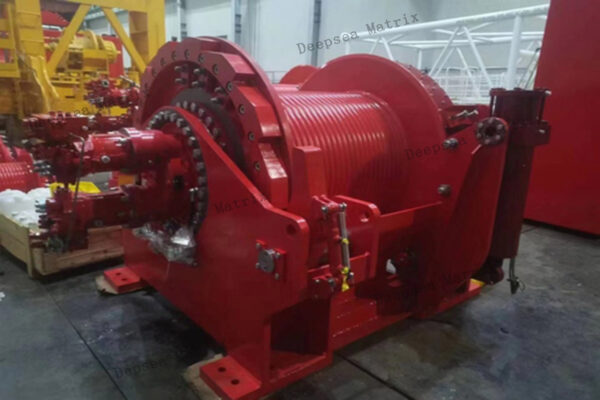 A robust hydraulic winch operating on a construction site.