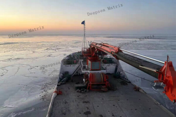 A marine crane transferring supplies to an offshore platform from a vessel from China