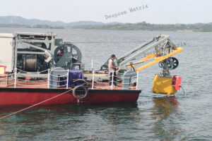 Launching a towed sonar fish from a vessel using a dedicated LARS during a survey mission.