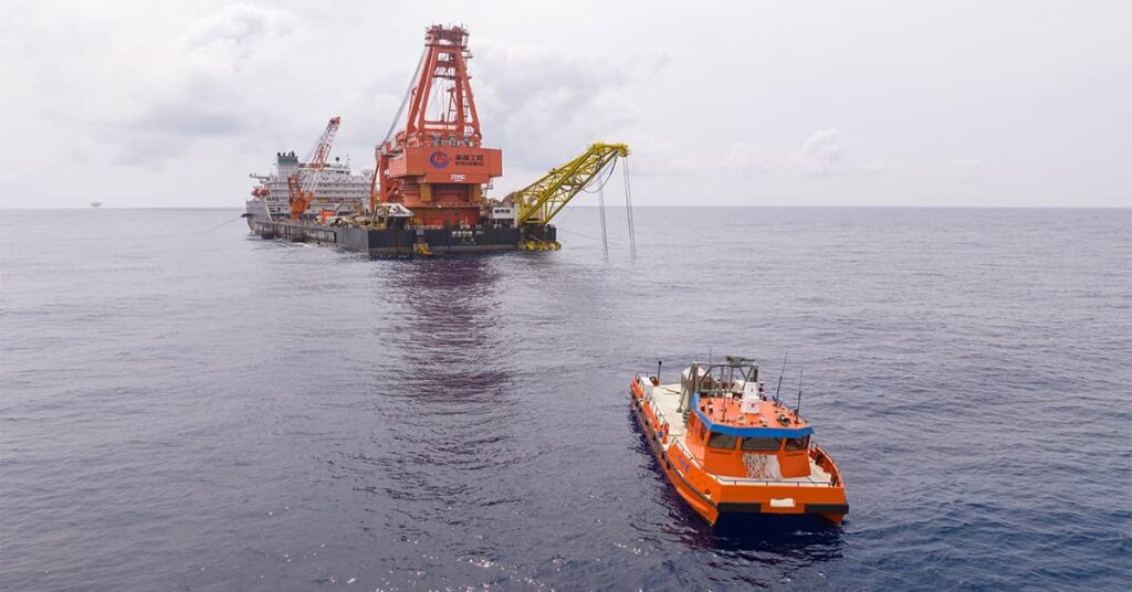 The CNOOC Hai Wei System during sea trials, featuring the Guardian USV operating near an offshore oil & gas platform for deepwater pipeline monitoring.