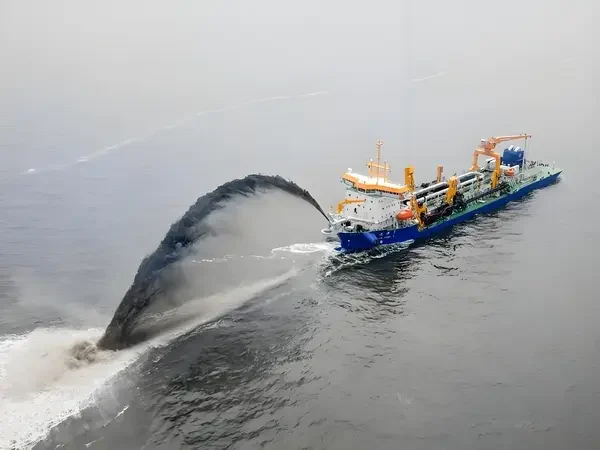 Port crane with grab bucket for dredging.