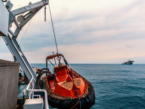 Lifeboat or FRC rescue boat in the vessel at sea. dsv ship is on background